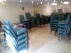 Chairs stacked awaiting the crew to set up for service in fellowship hall